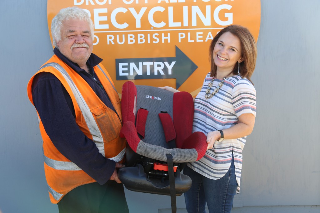 Palmerston North City Councillor, Rachel Bowen hands over an expired child car seat to Ferguson Street Recycling Centre worker Wayne ‘Woody’ Woods. The SeatSmart child car seat recycling programme will be available at the centre from January 13. PHOTO: Palmerston North City Council